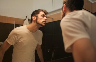 man looking in mirror
